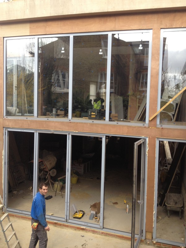 Aluminium bi-fold doors with two-storey glazing in Tooting