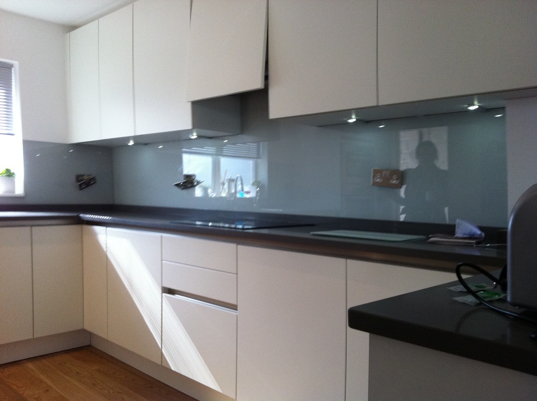 Grey glass kitchen splashback with LED lighting in Tooting