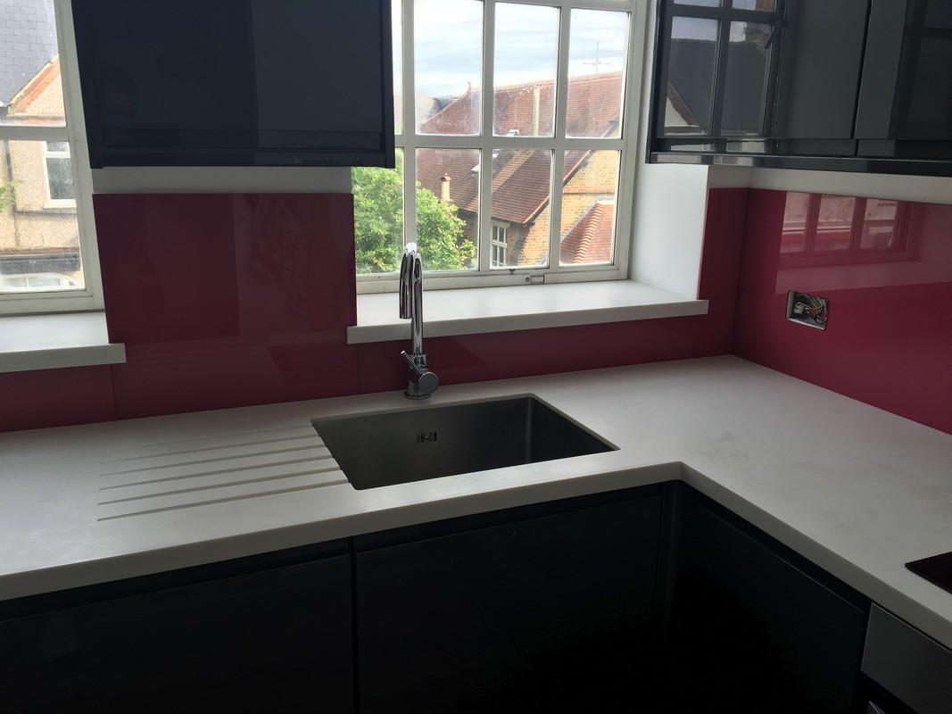 Deep plum coloured glass splashback in modern Tooting kitchen