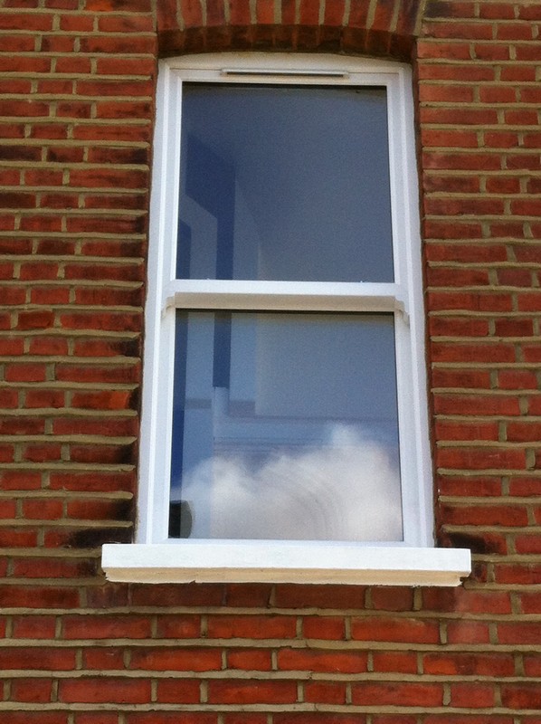 uPVC sash window on Victorian red brick house in Tooting